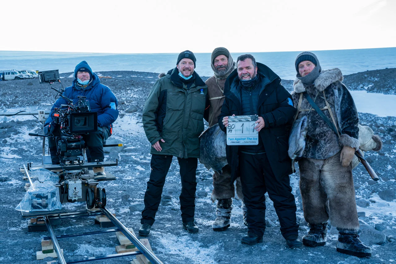 Against the Ice cast and filmmakers on set with the clapperboard