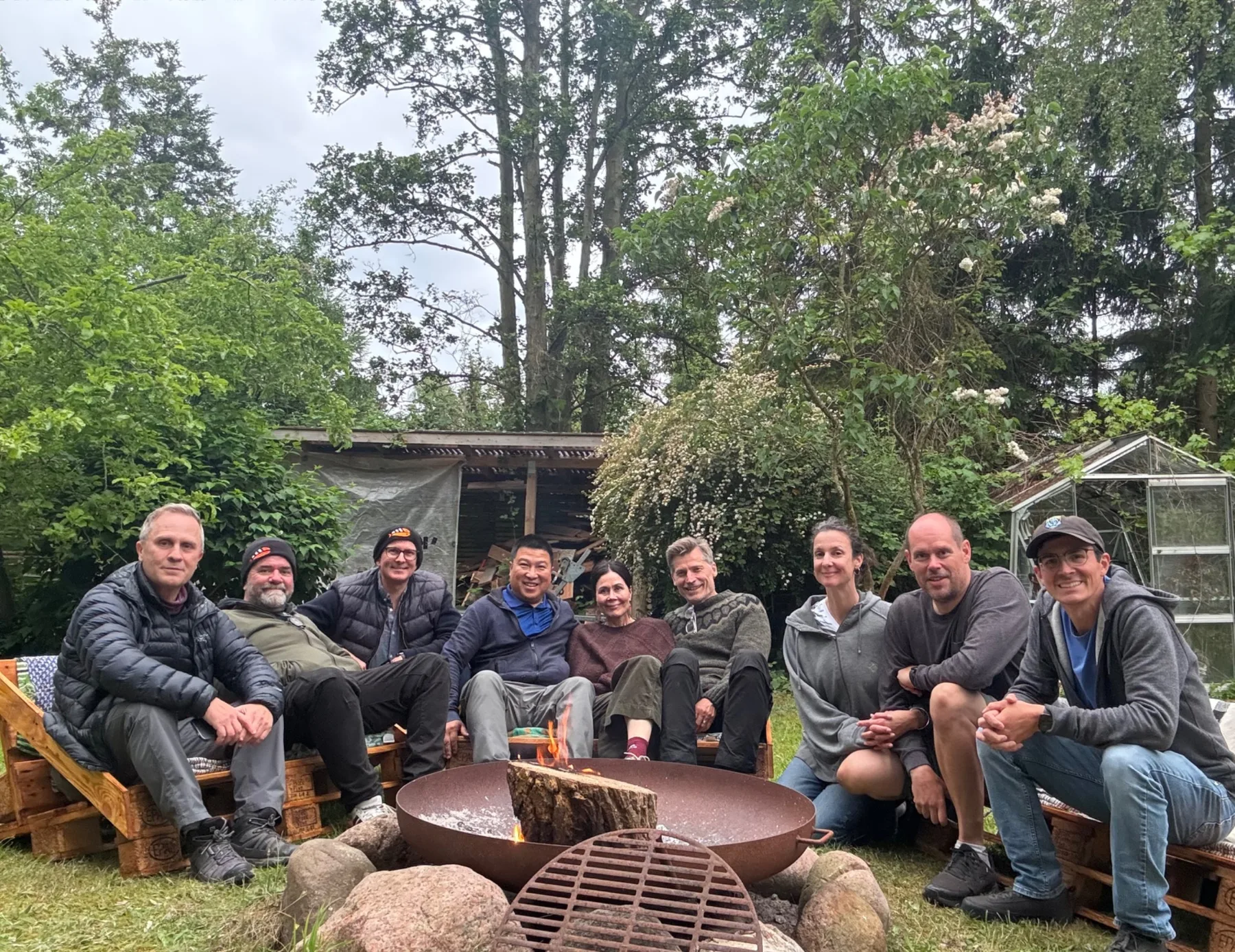 An Optimist’s Guide to the Planet crew gathered around a fire