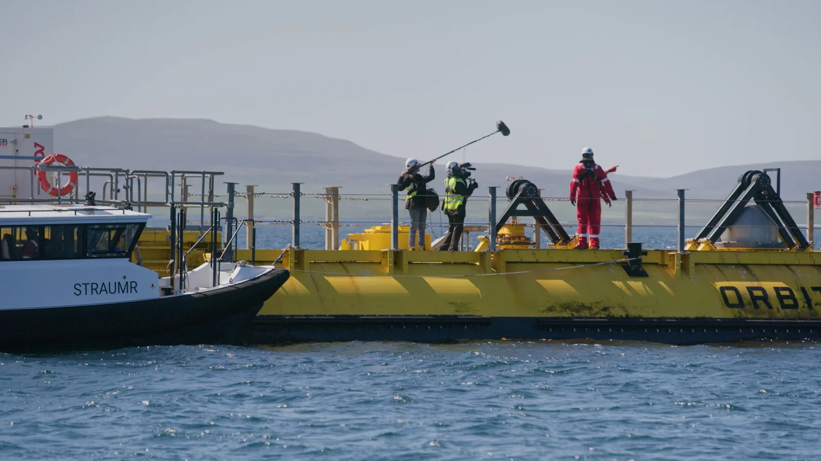 Camera and sound crew filming on an offshore energy platform